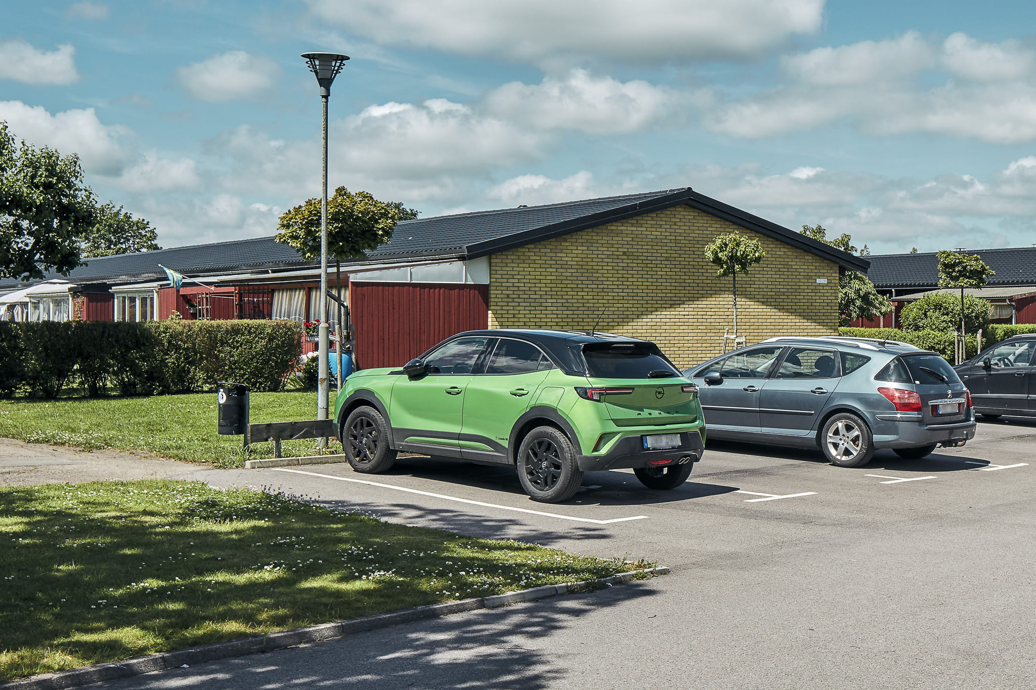 Bilar parkerade framför radhuslägenheter Brogårda