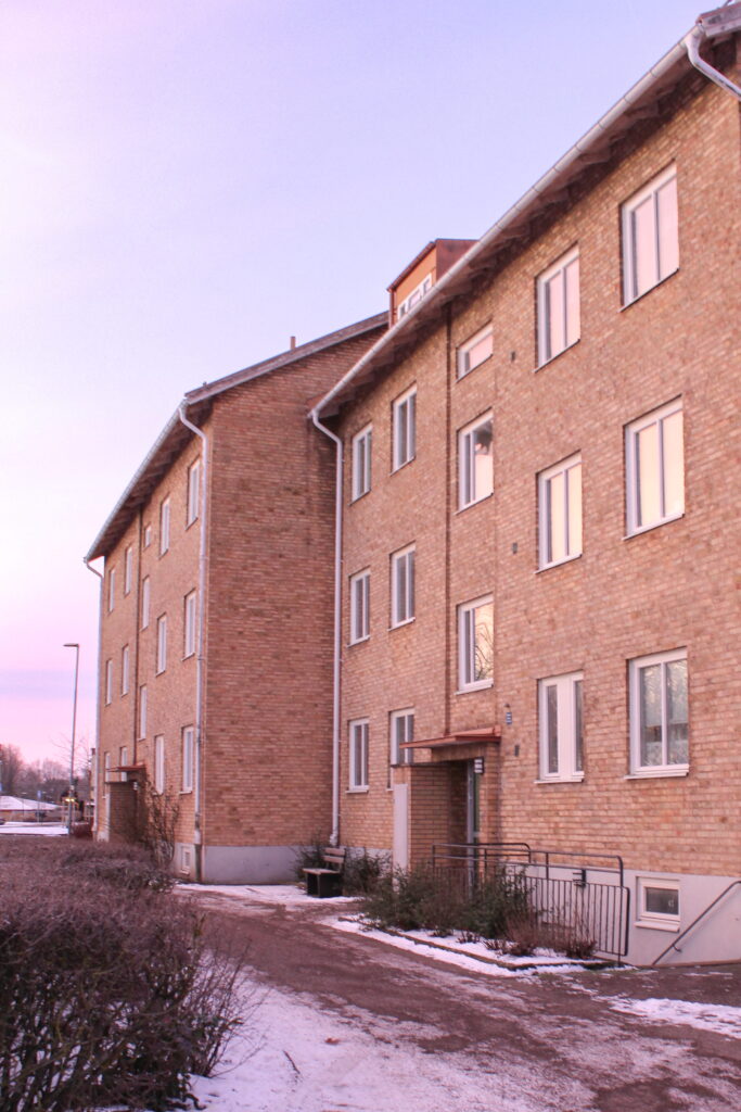 Gul tegelhusfasad i soluppgång